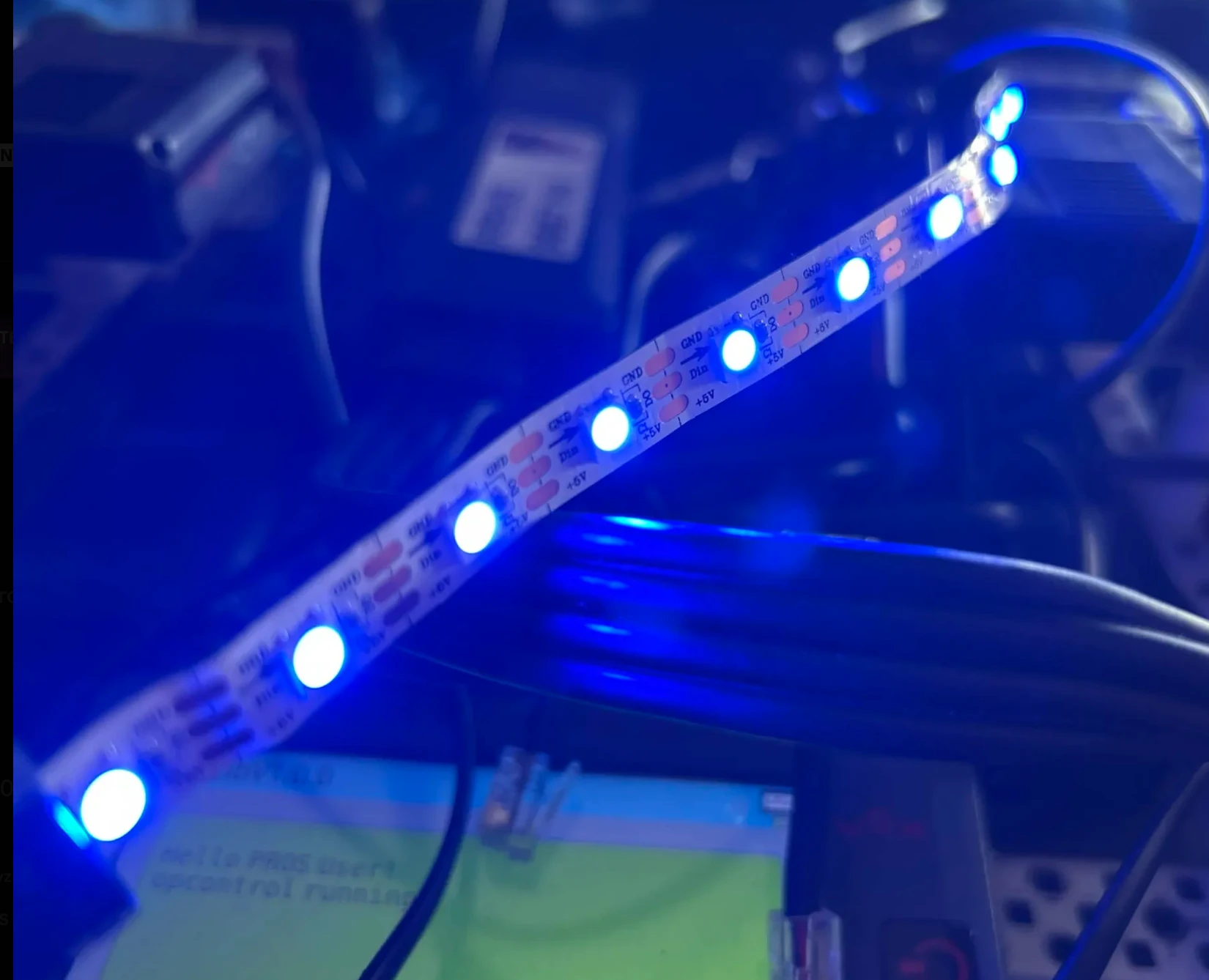 Closeup of a blue-lit WS2812B strip wired to a test controller