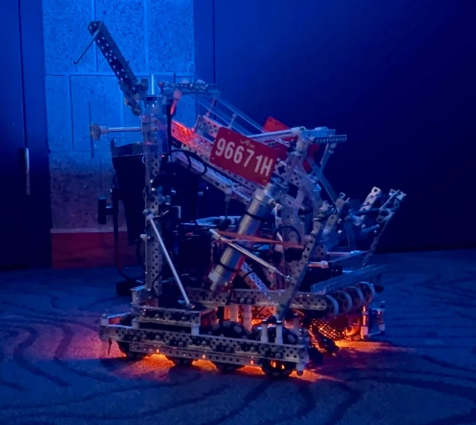 Team 96671H's competition robot, underglow lit, on the reveal stage